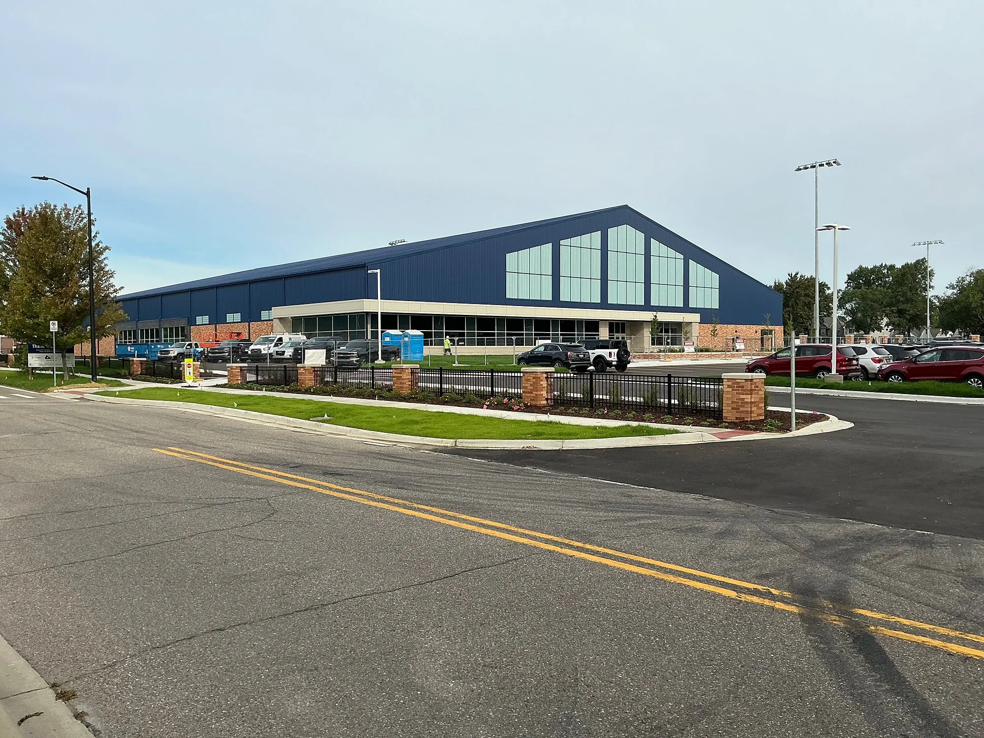 The new BEAR Complex field house with a blue standing-seam roof and glass gable end