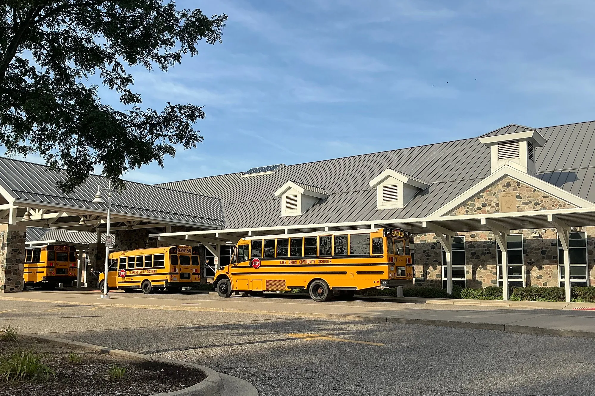 Wing Lake Developmental Center with school buses lined up under the covered drop-off