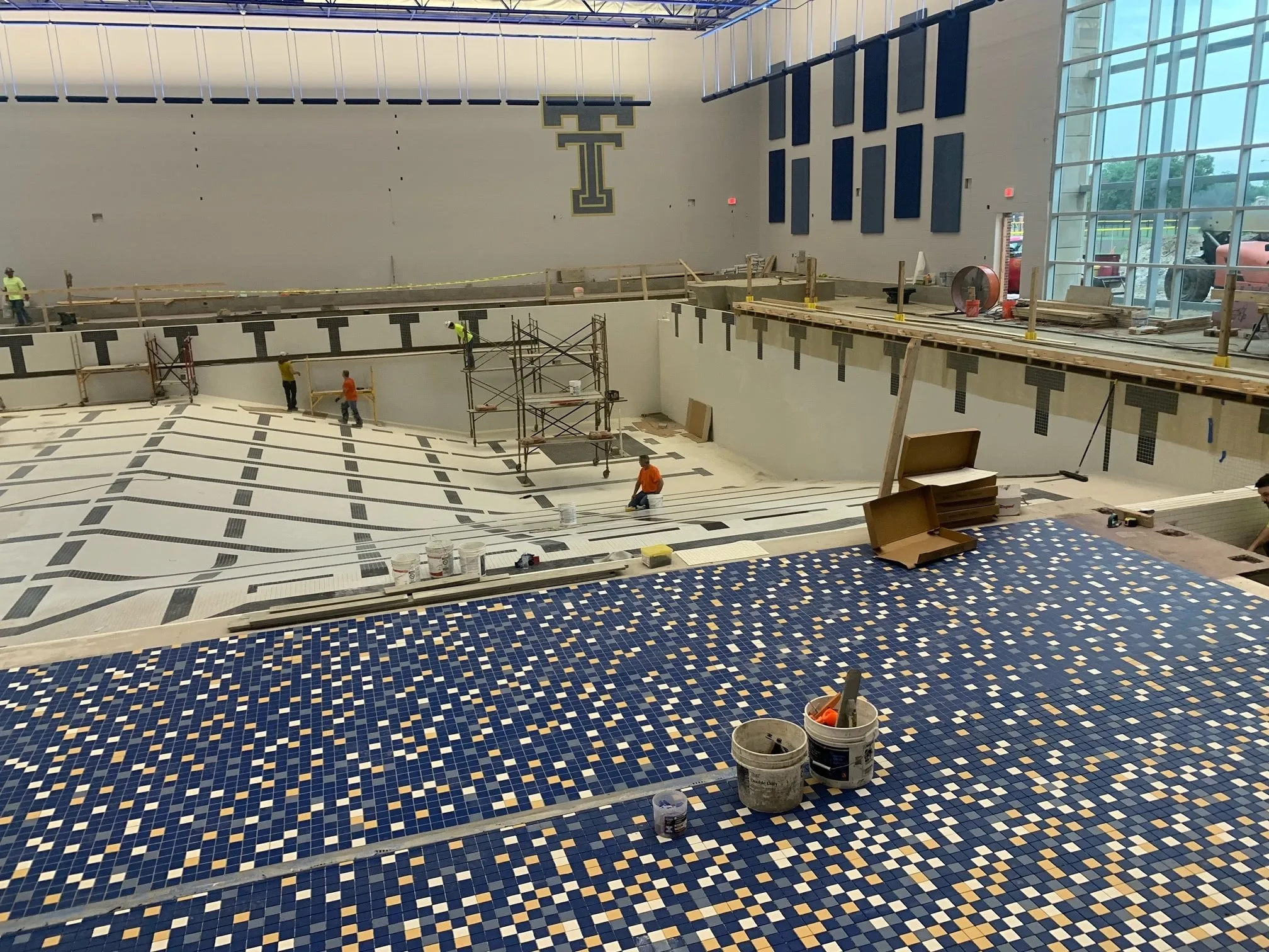Tile crews building a new school natatorium